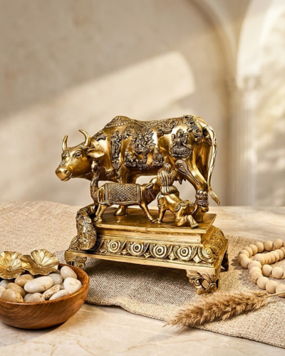 Brass cow with little krishna